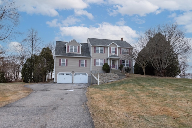 view of front of property with a front yard and a garage