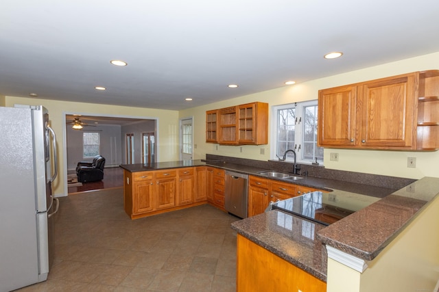 kitchen featuring ceiling fan, dishwasher, refrigerator, kitchen peninsula, and sink