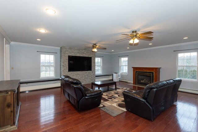 living room featuring dark wood-type flooring, crown molding, a stone fireplace, and ceiling fan