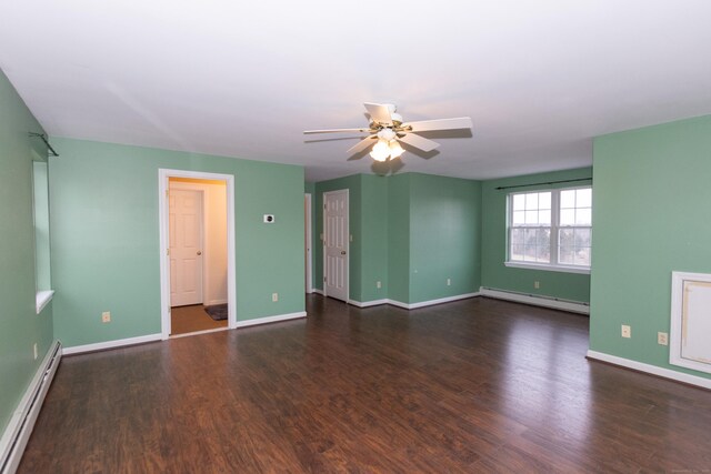 spare room with ceiling fan, baseboard heating, and dark wood-type flooring