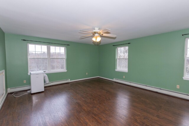 empty room featuring a baseboard heating unit, ceiling fan, and a healthy amount of sunlight