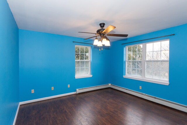 spare room featuring ceiling fan, wood-type flooring, and a baseboard radiator