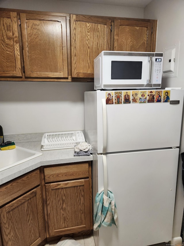 kitchen with sink and white appliances