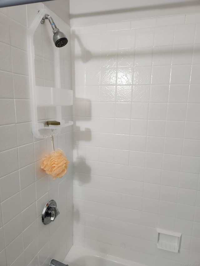 interior details featuring tiled shower / bath