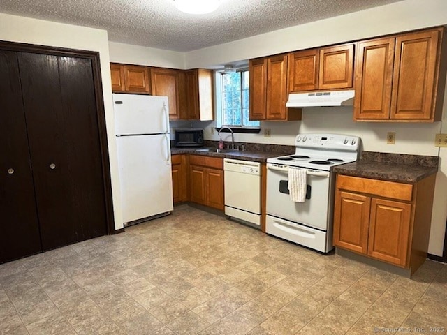 kitchen with white appliances, a textured ceiling, and sink