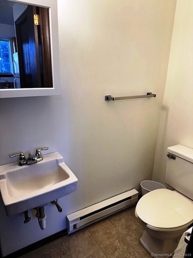 bathroom with sink, tile patterned floors, toilet, and baseboard heating