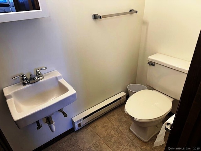 bathroom featuring sink, tile patterned flooring, a baseboard radiator, and toilet