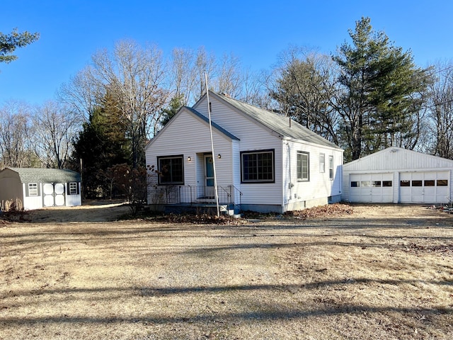 view of front of property with a storage unit and a garage