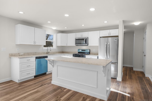 kitchen with a kitchen island, white cabinets, and appliances with stainless steel finishes