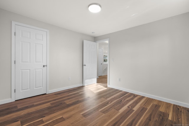 spare room with dark hardwood / wood-style floors