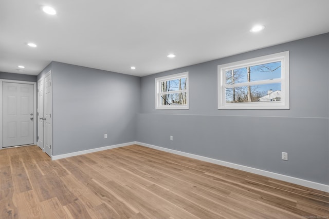 basement with light hardwood / wood-style floors