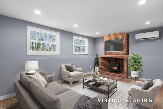 living room featuring a wall mounted air conditioner, a wood stove, and hardwood / wood-style floors