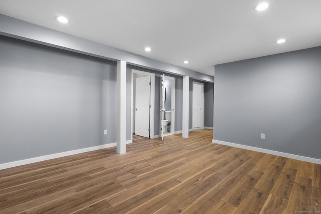 basement with dark hardwood / wood-style floors