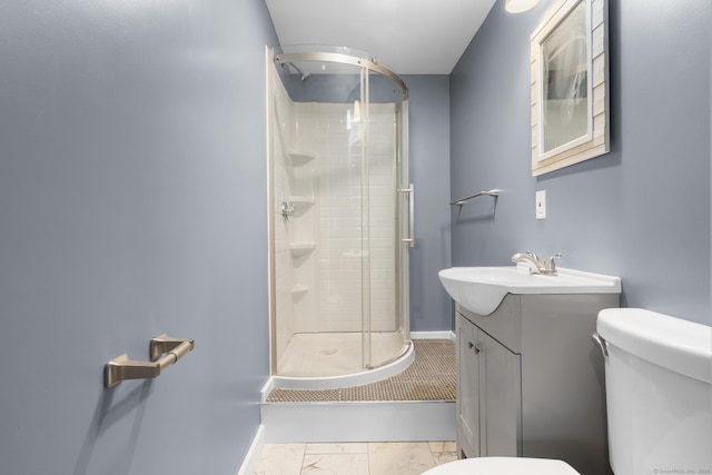 bathroom featuring an enclosed shower, vanity, and toilet