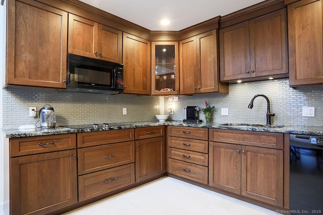 kitchen with sink, decorative backsplash, black appliances, and stone countertops