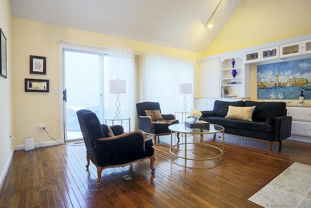 living room featuring dark hardwood / wood-style flooring and high vaulted ceiling