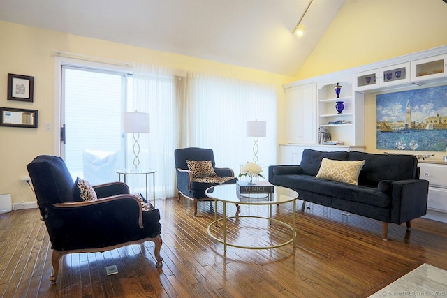 living room with wood-type flooring and vaulted ceiling