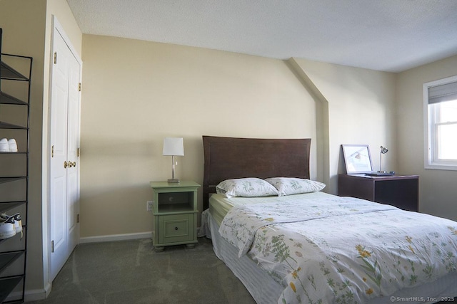 bedroom featuring dark carpet