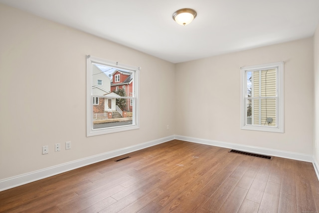 spare room with hardwood / wood-style floors