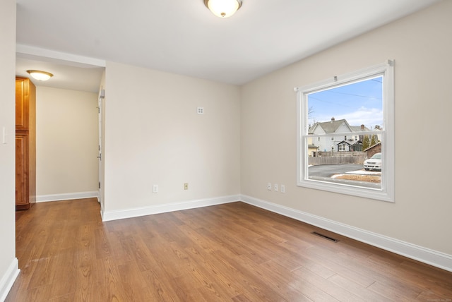 empty room with light hardwood / wood-style flooring