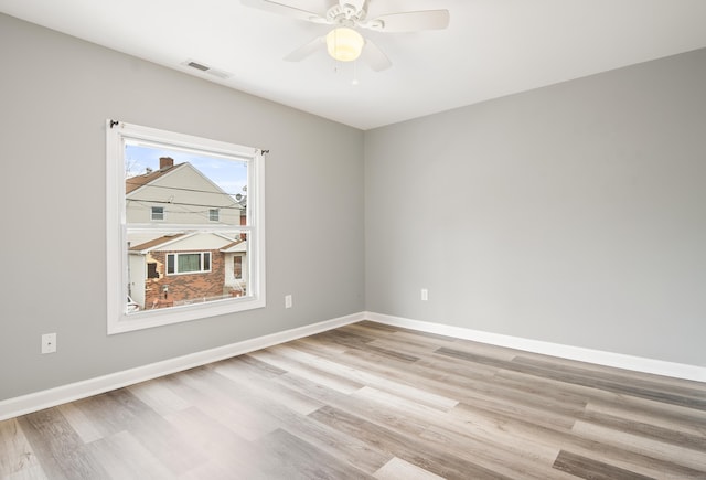 spare room featuring light hardwood / wood-style floors and ceiling fan