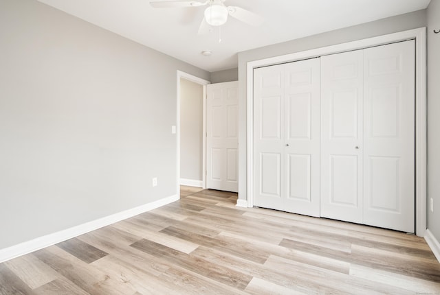 unfurnished bedroom with ceiling fan, light hardwood / wood-style floors, and a closet