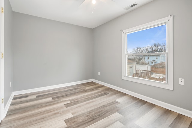 unfurnished room with ceiling fan and light wood-type flooring