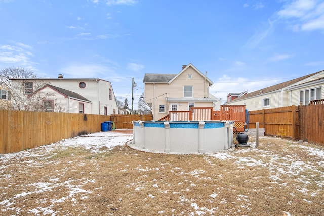 yard covered in snow with a fenced in pool