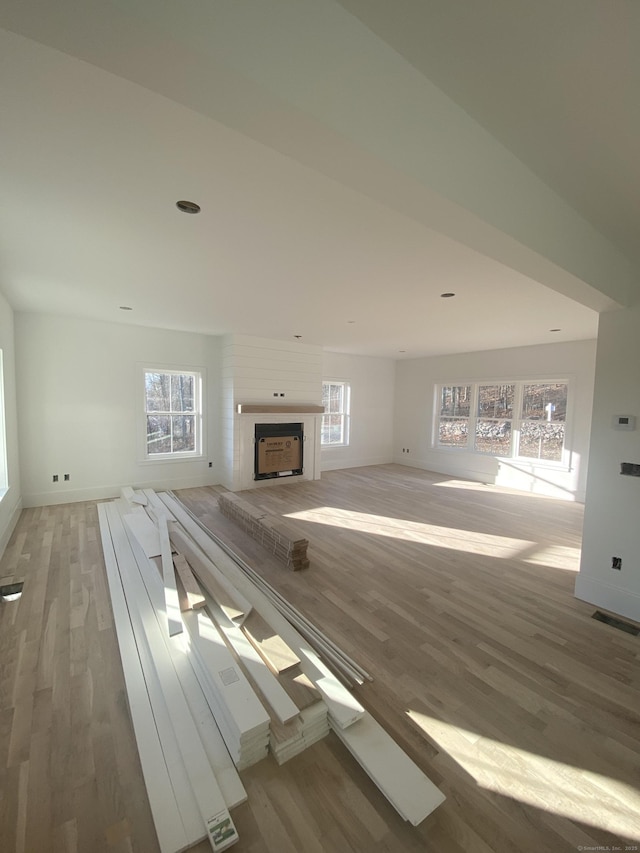 unfurnished living room featuring hardwood / wood-style flooring