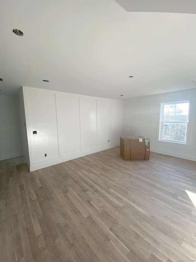 bonus room with light wood-type flooring