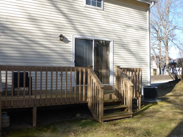 doorway to property with a deck and central AC unit