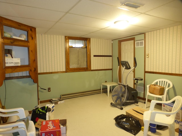 exercise area with a drop ceiling and a baseboard radiator