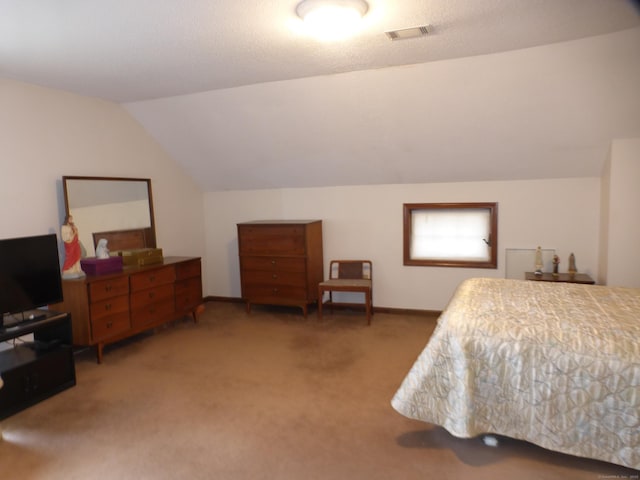 bedroom featuring vaulted ceiling and carpet