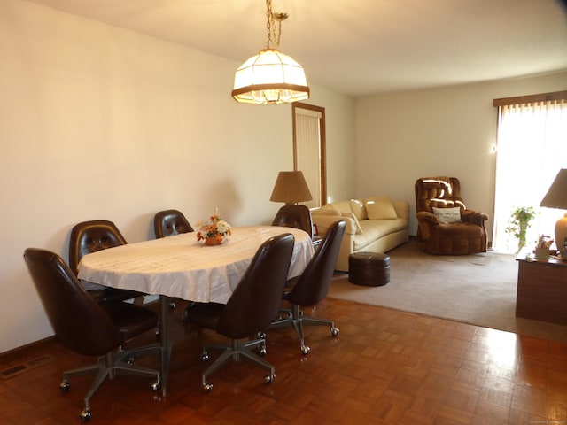 dining area with parquet floors