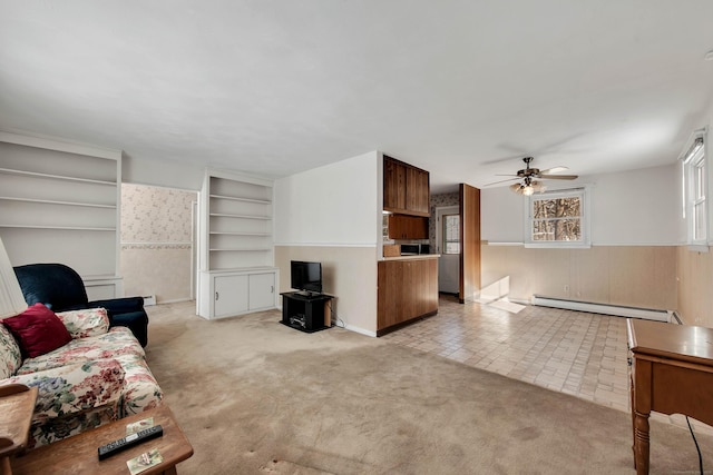 living room featuring ceiling fan, baseboard heating, and light colored carpet