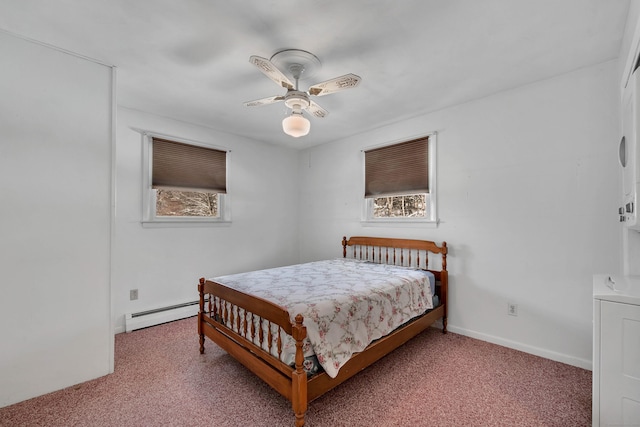 bedroom featuring ceiling fan, a baseboard radiator, multiple windows, and carpet floors