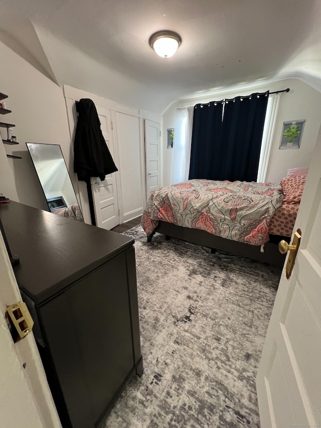 carpeted bedroom featuring lofted ceiling