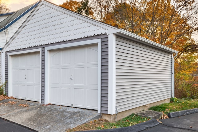 view of garage at dusk