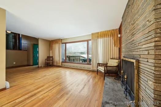 unfurnished living room featuring wood-type flooring and a fireplace