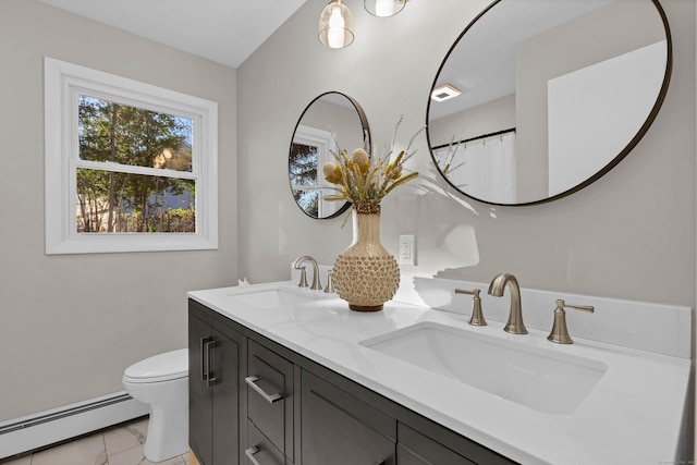 bathroom with vanity, toilet, and a baseboard heating unit