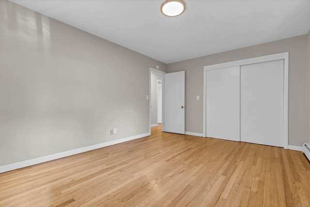 unfurnished bedroom with light hardwood / wood-style floors and a closet