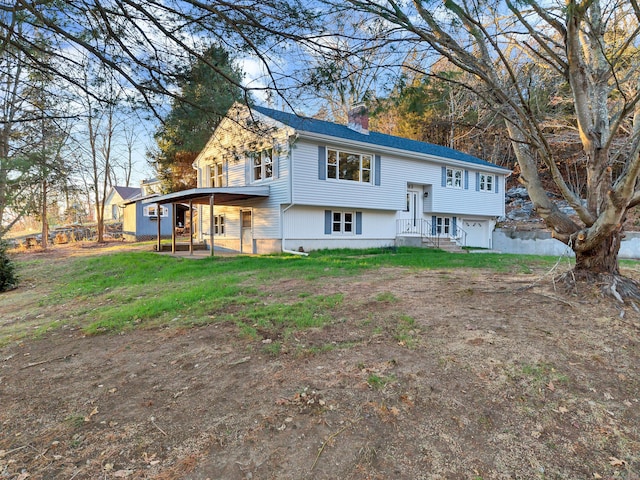 view of front of property featuring a garage and a front lawn