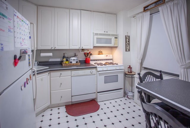 kitchen featuring white cabinetry, white appliances, and sink