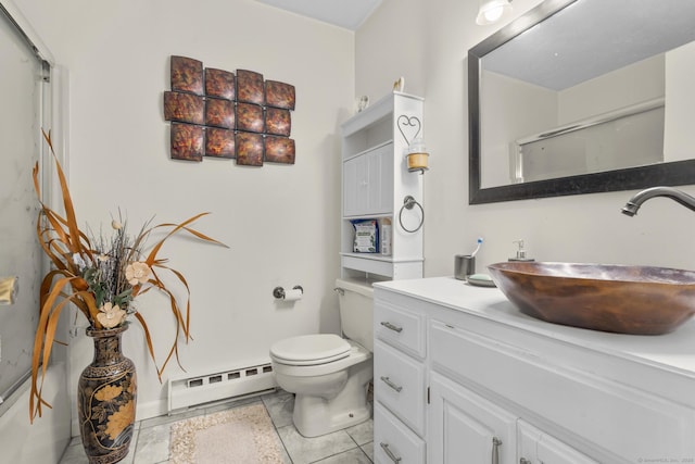 bathroom with tile patterned flooring, toilet, vanity, a shower with shower door, and a baseboard radiator