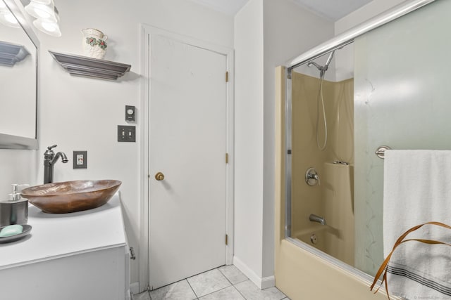 bathroom featuring combined bath / shower with glass door, tile patterned flooring, and vanity