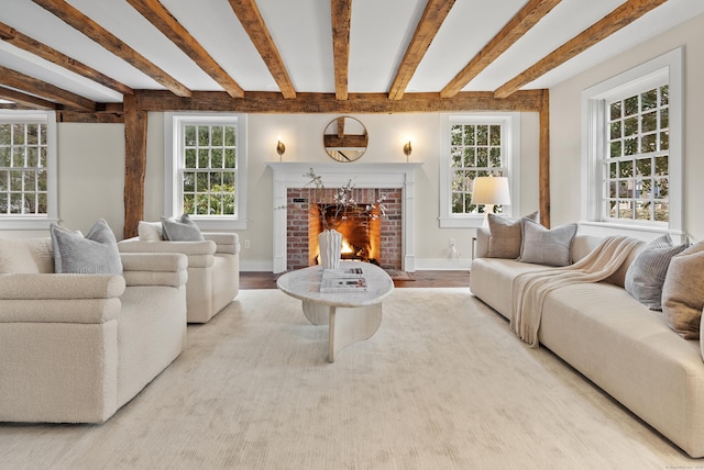 living room featuring a brick fireplace, beam ceiling, and light hardwood / wood-style floors