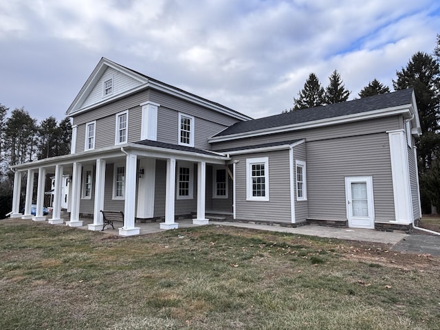 view of front of property with covered porch and a front yard