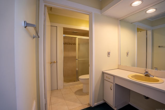 bathroom with toilet, an enclosed shower, tile patterned flooring, and vanity