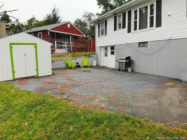 view of patio / terrace featuring a storage shed and area for grilling