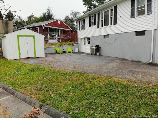 view of yard with a storage shed and a patio area